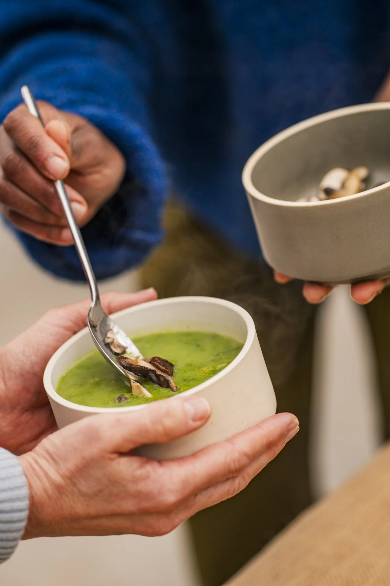 Brunch of Growing a meal, Michel Gonzaga is pouring soup in a bowl of one of the participants during her workshop.