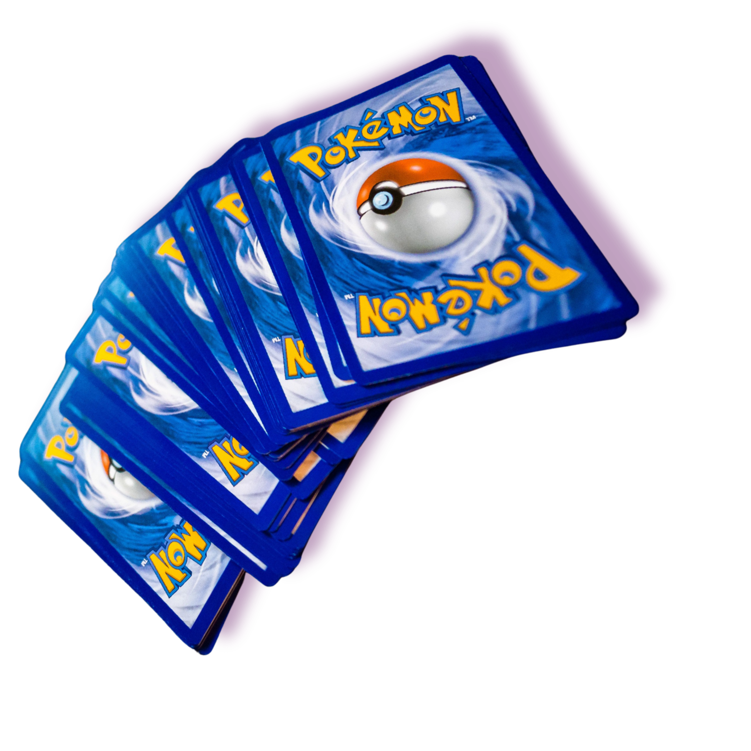 Multiple Pokémon trading cards fanned out on a surface, with the top card showing a Poké Ball and the Pokémon logo.