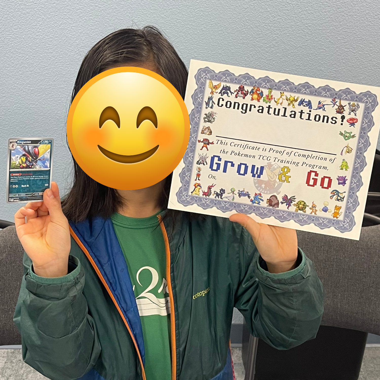 Person holding a Pokémon trading card and a certificate of completion for the Pokémon TCG training program.