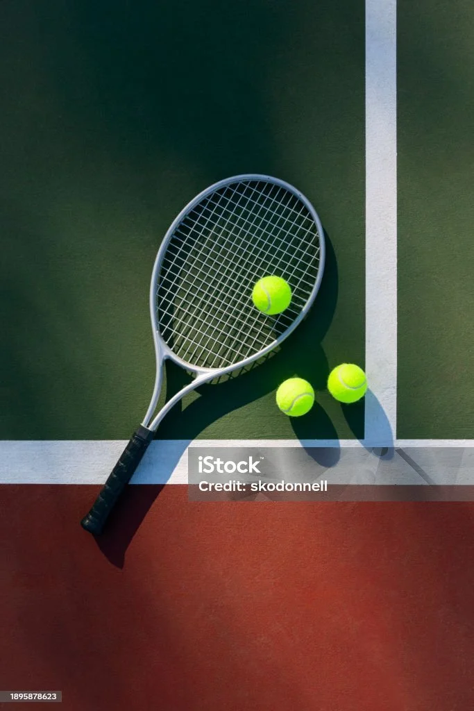 Tennis racket and balls on a tennis court
