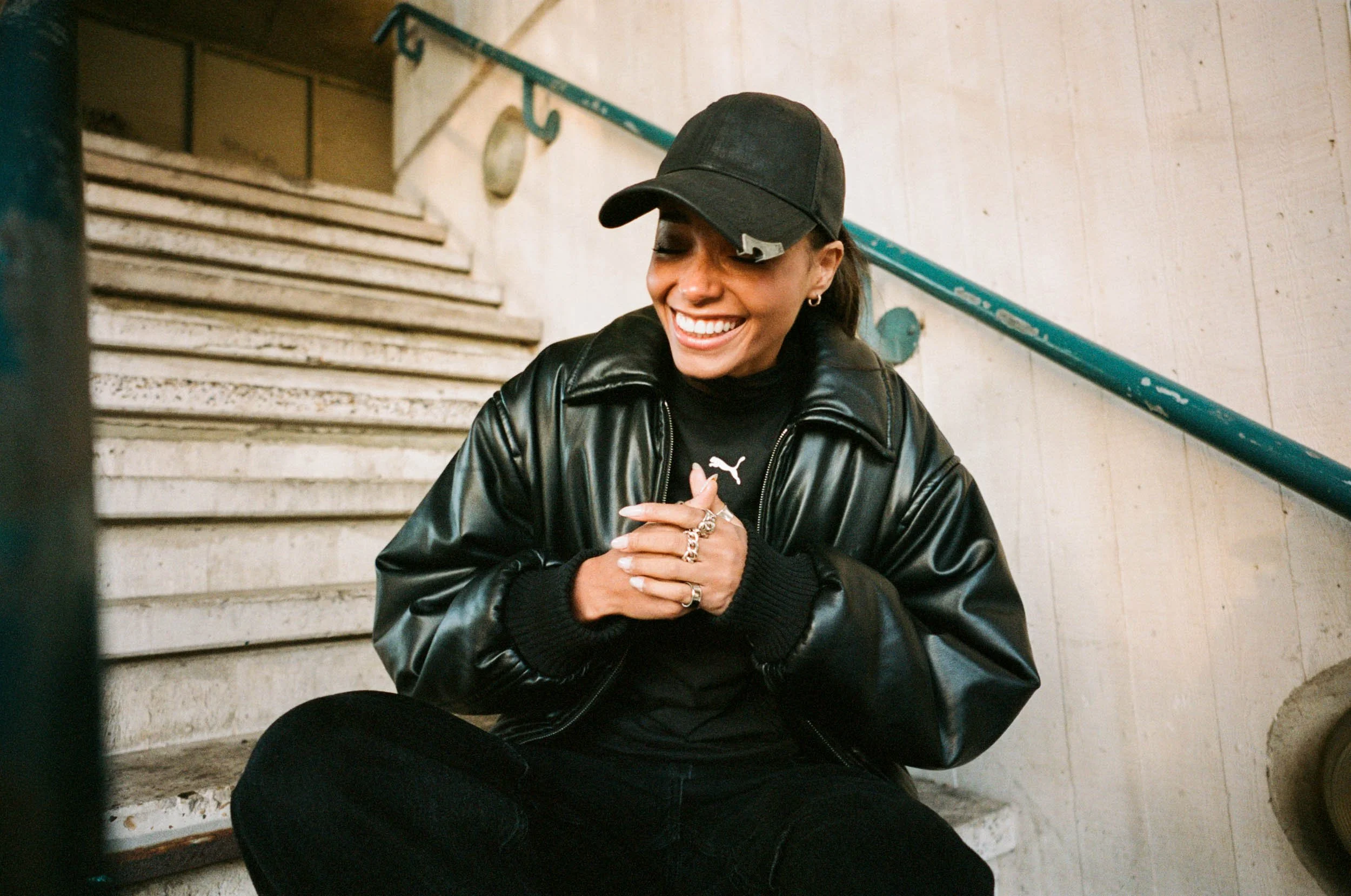 Editorial portrait of Linska sitting on stairs, photographed by Dan Medhurst for Luna Collective.
