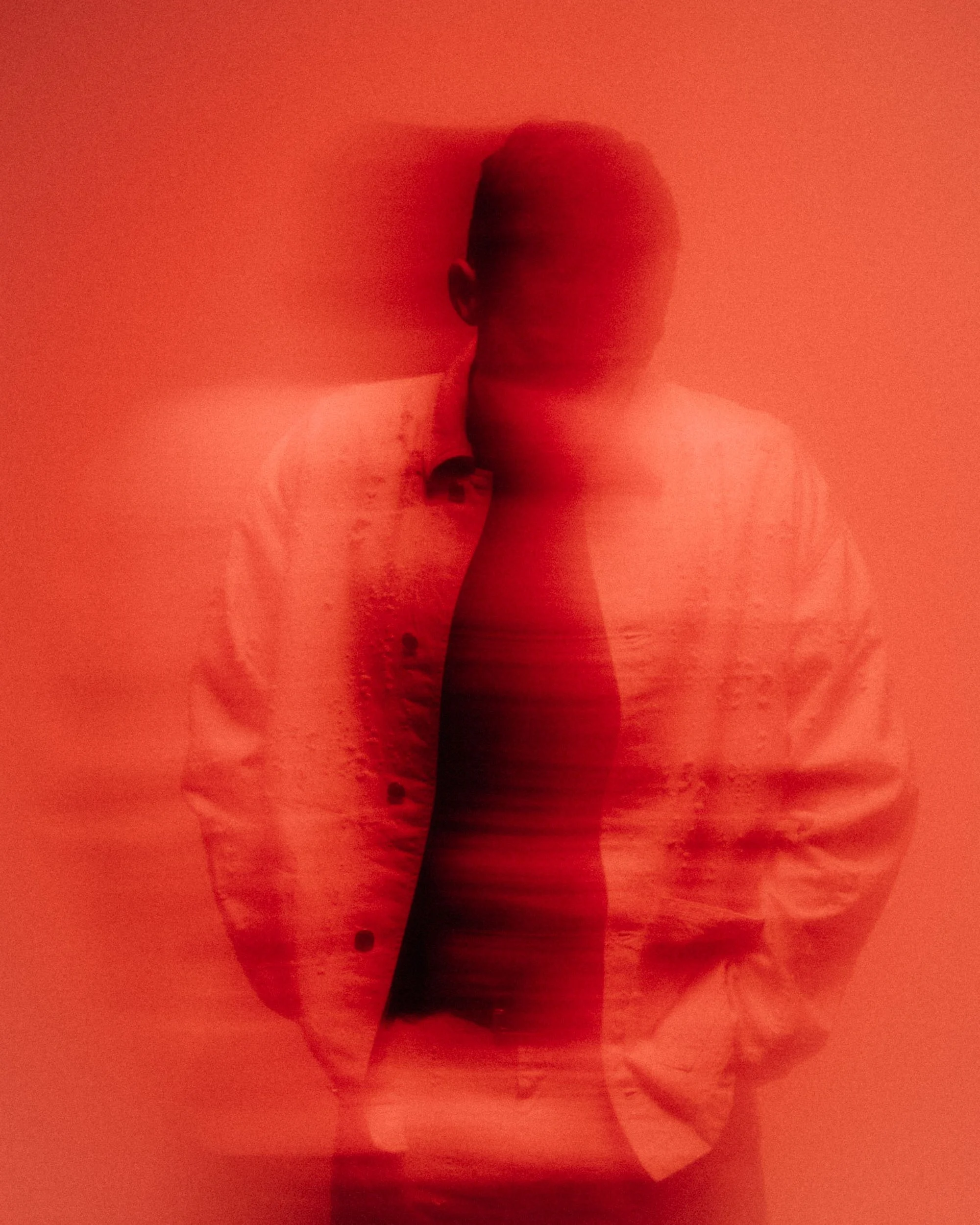 Red studio portrait of Ben Böhmer photographed by Dan Medhurst in Berlin for Ninja Tune.