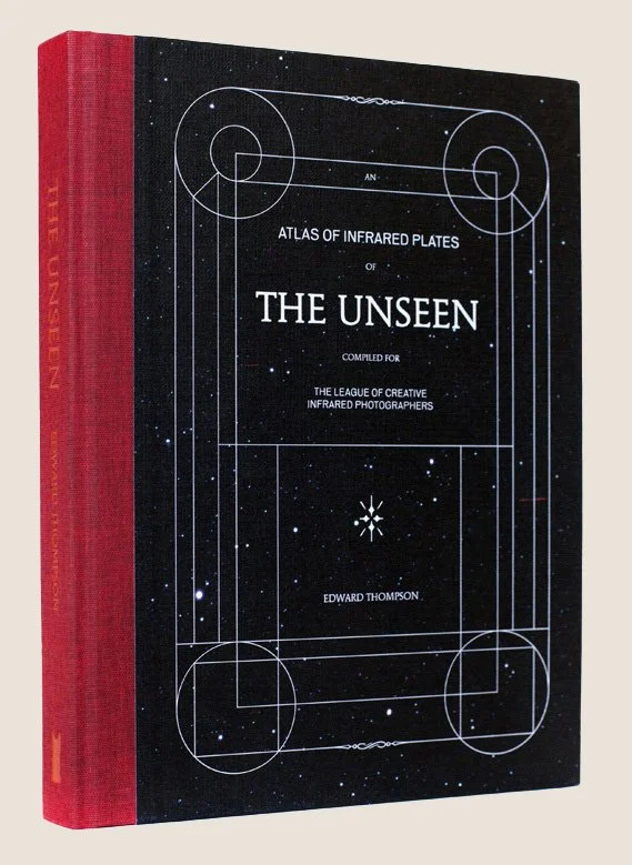A hardcover book titled 'Atlas of Infrared Plates of The Unseen,' compiled for the League of Creative Infrared Photographers by Edward Thompson. The cover has a starry night sky design with white geometric lines.