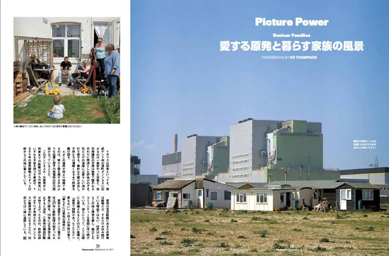 A magazine spread with a large nuclear power plant in the background and small homes in the foreground. The right page has the title "Picture Power" and some text in Japanese. The left page shows a family outdoors with children playing in the yard.