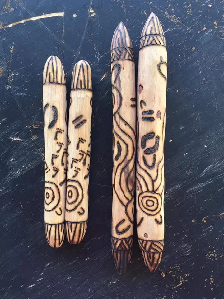 Two sets of engraved wooden message sticks. 