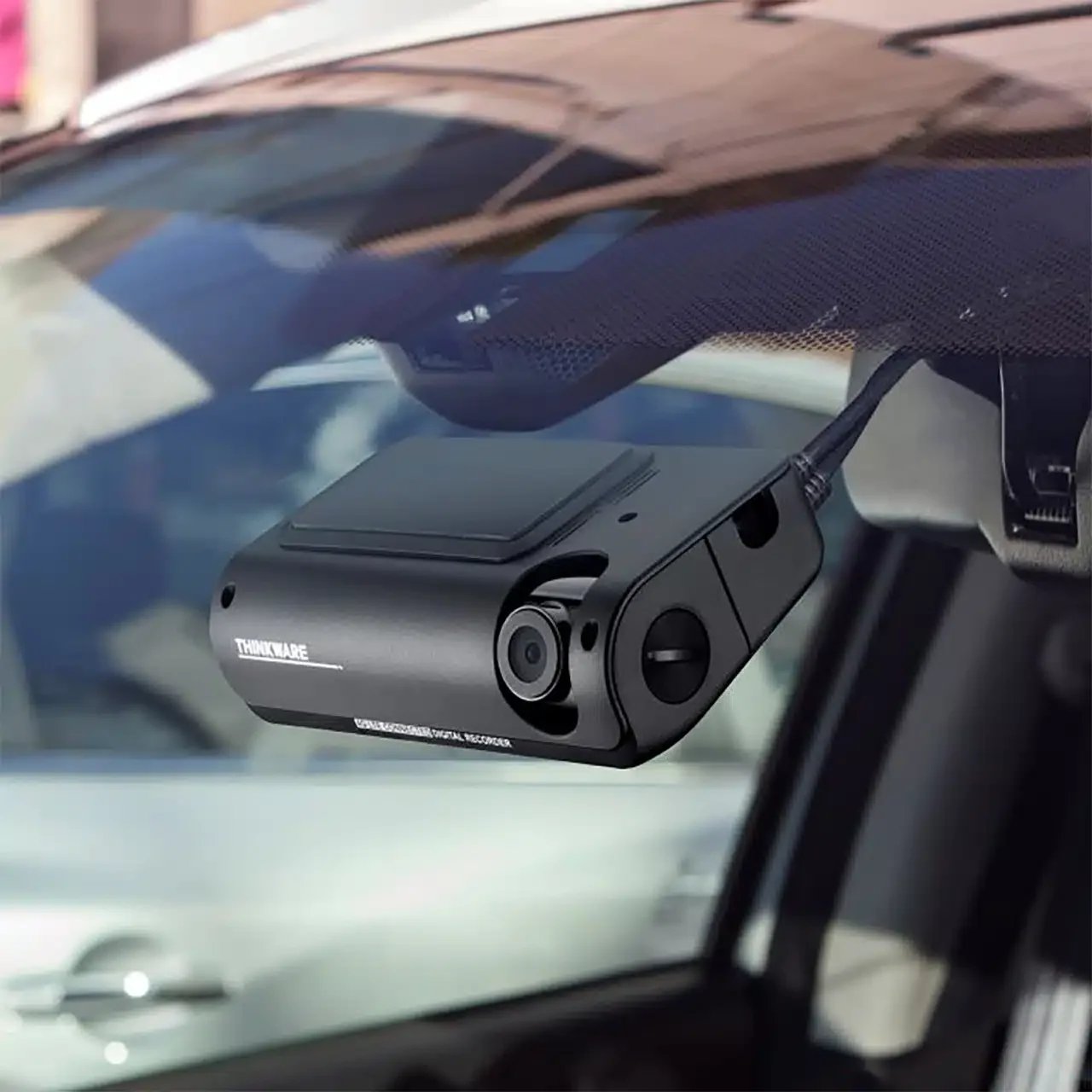 Dashcam mounted on a car's windshield.