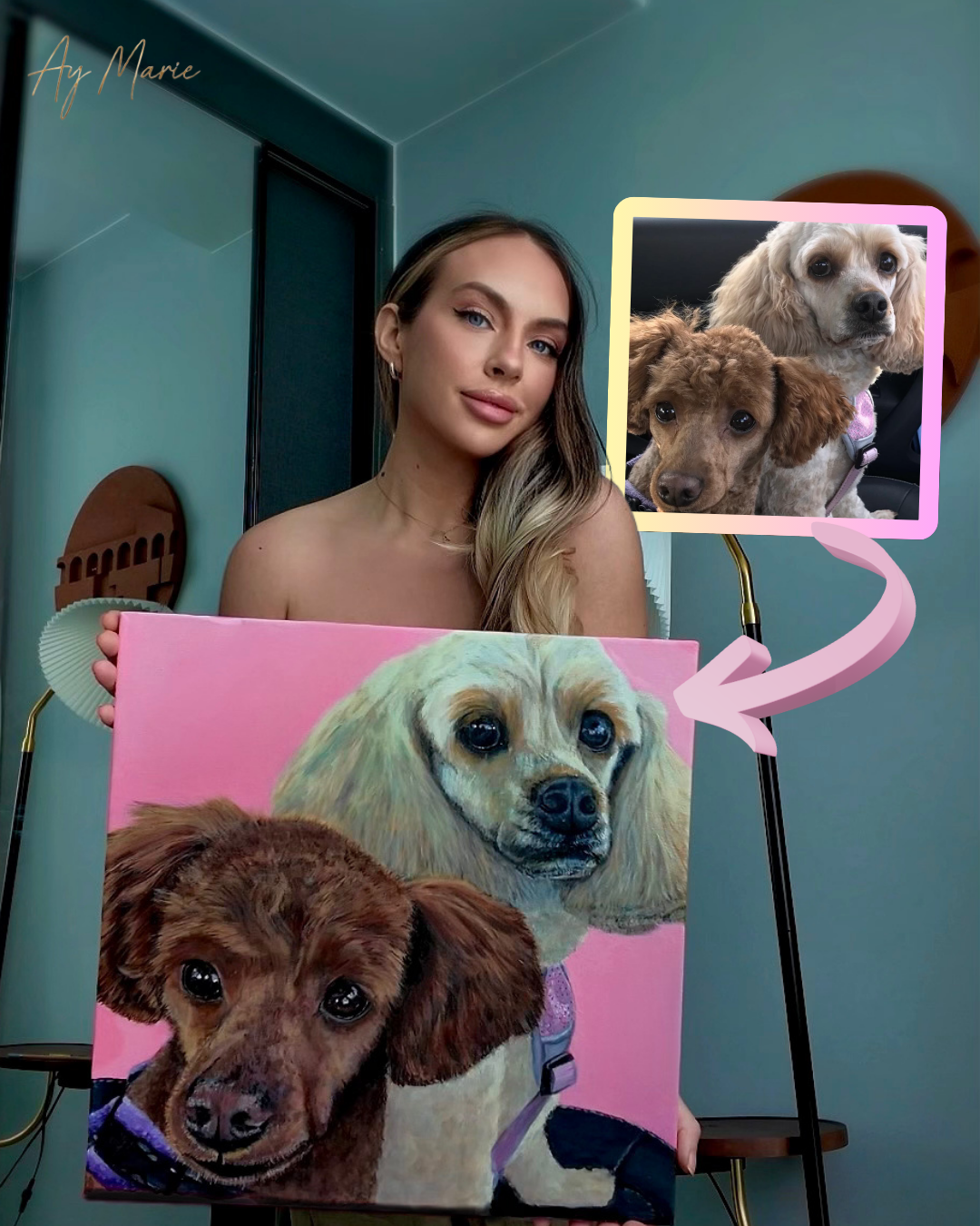 A woman holding a painted portrait of two dogs in front of her, with a reference photo of the same dogs displayed on a lamp. The woman has long blonde hair and is in a room with teal walls and a wooden door.