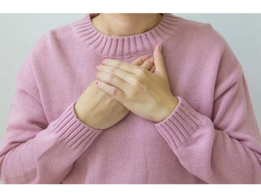 Woman easing chest tightness after mastectomy or radiation