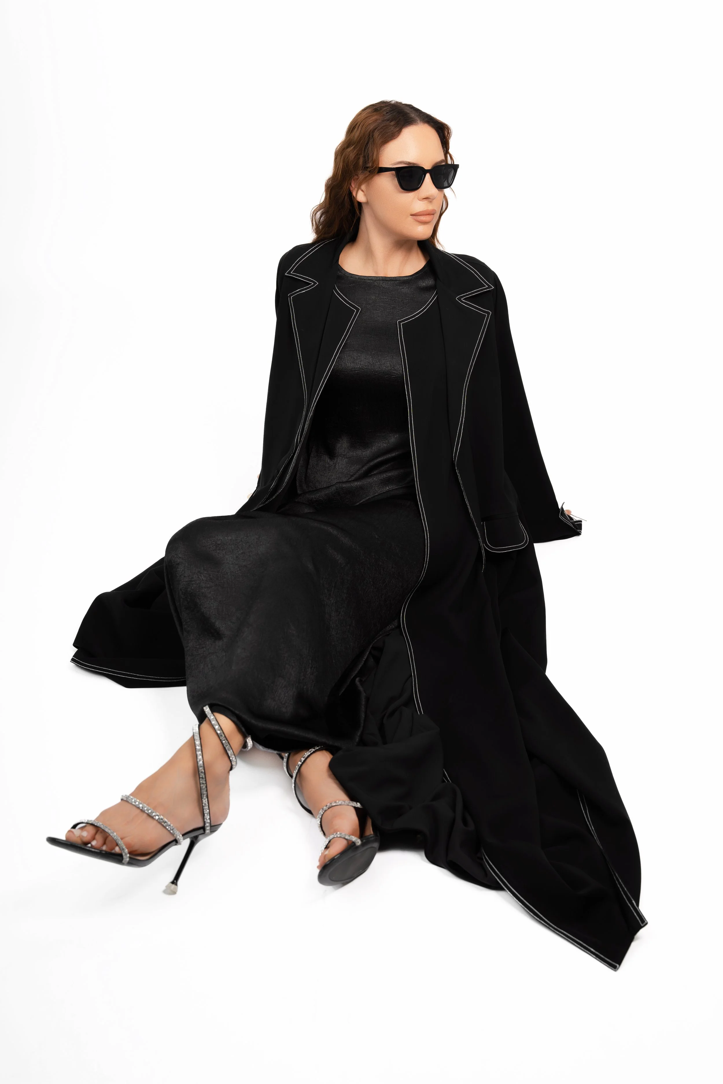 High-fashion photography in Dubai of a model in a black blazer and sunglasses, styled shoot by a professional Dubai photographer and videographer.
