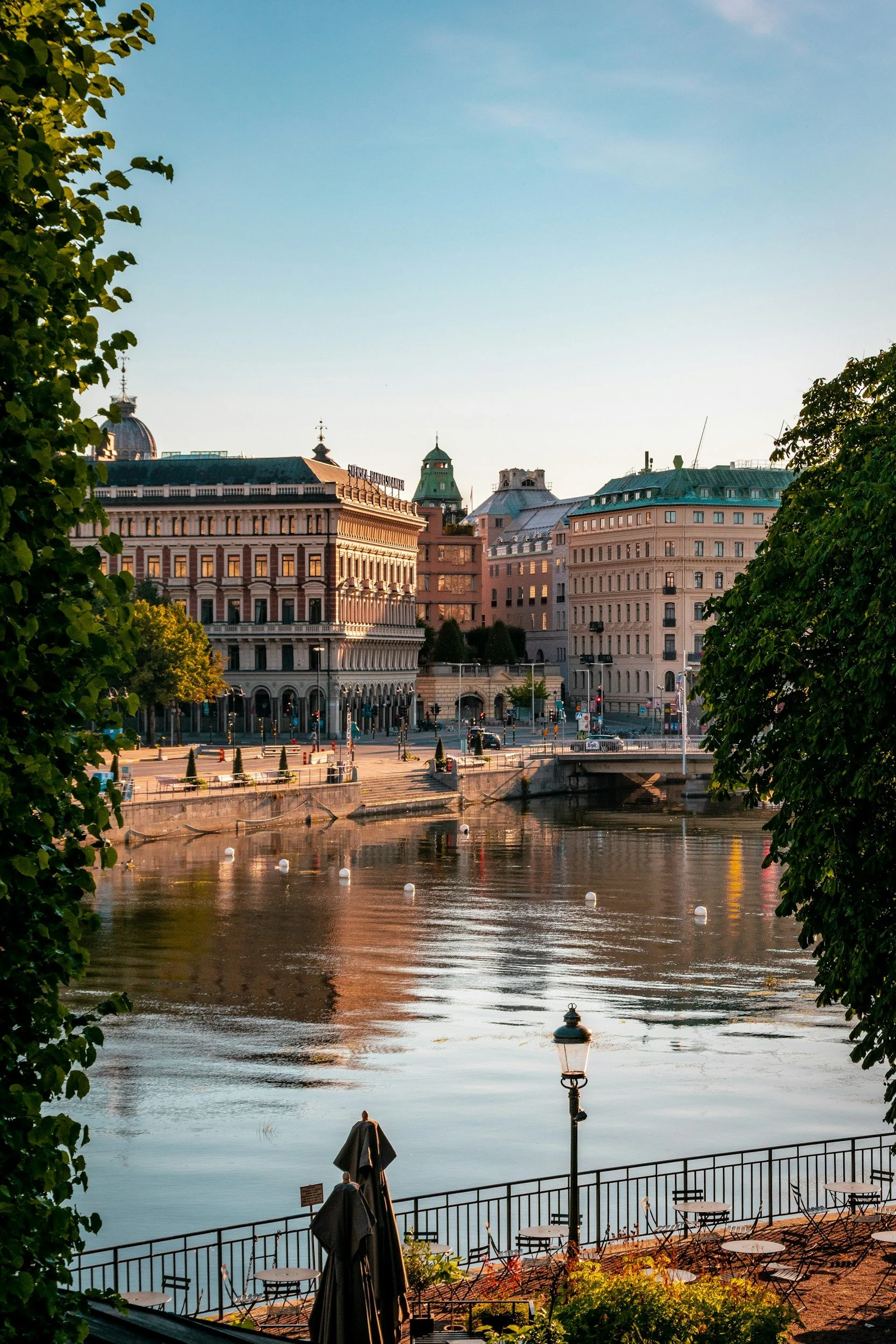 Historic waterfront buildings in central Stockholm, Sweden, viewed across the canal in warm evening light.