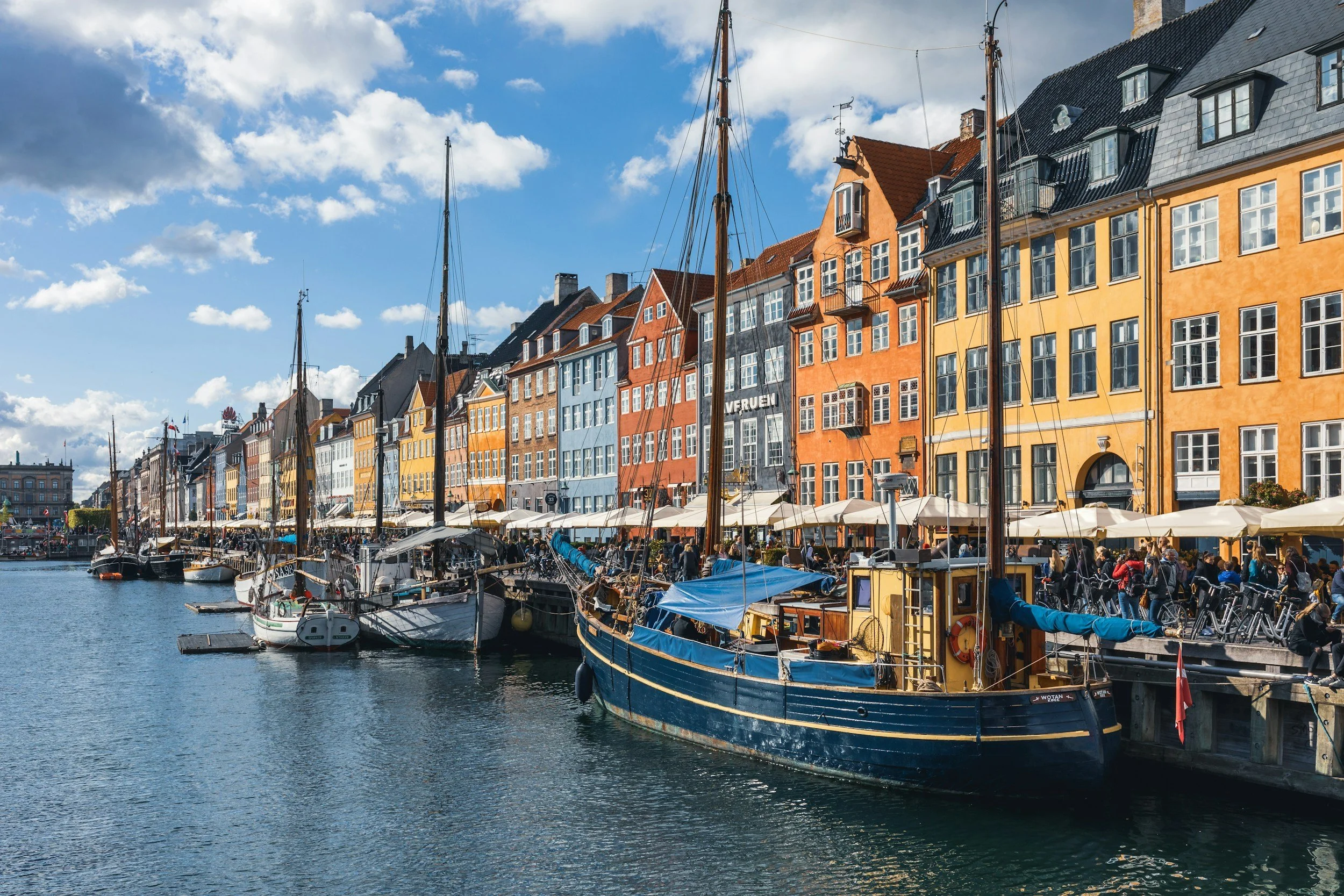 Colourful townhouses, outdoor cafés and traditional boats along Copenhagen’s Nyhavn waterfront.