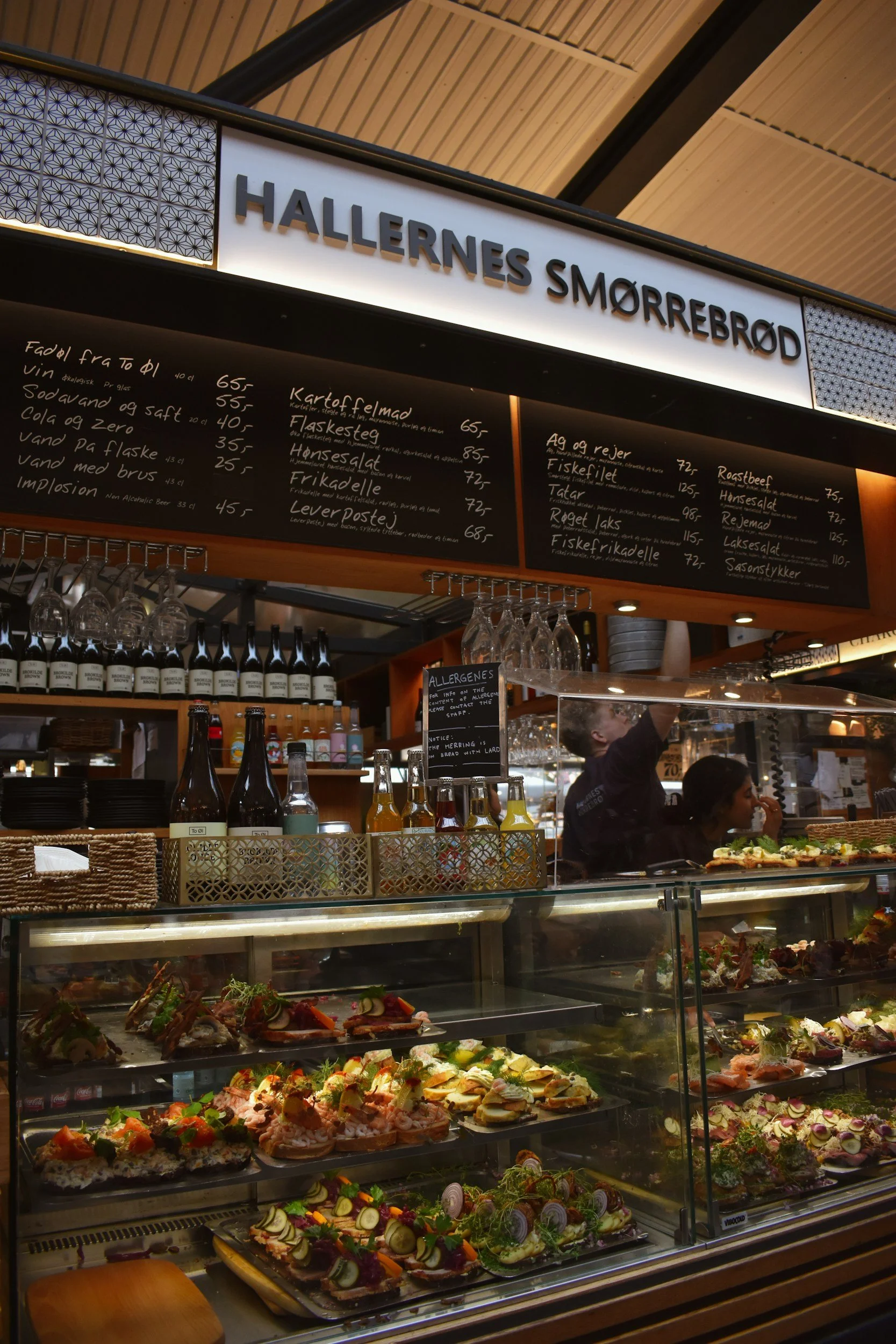 Traditional Danish open sandwiches displayed at a smørrebrød counter in Copenhagen.
