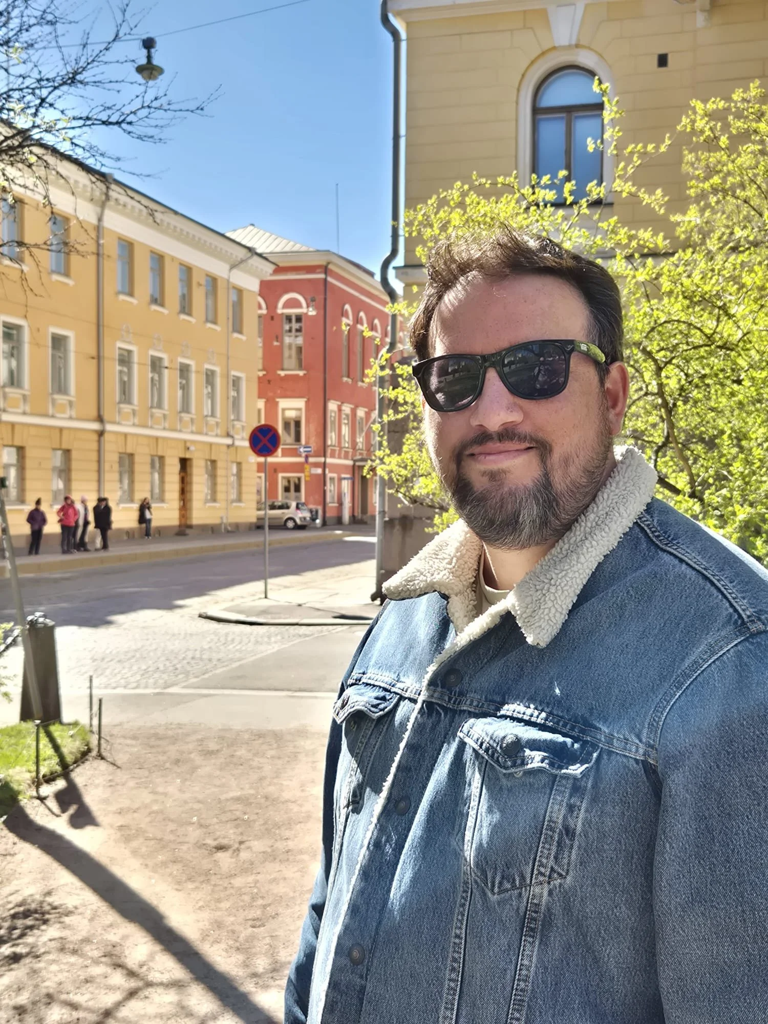 Nordic Travel Table founder outdoors among colourful historic buildings in Scandinavia
