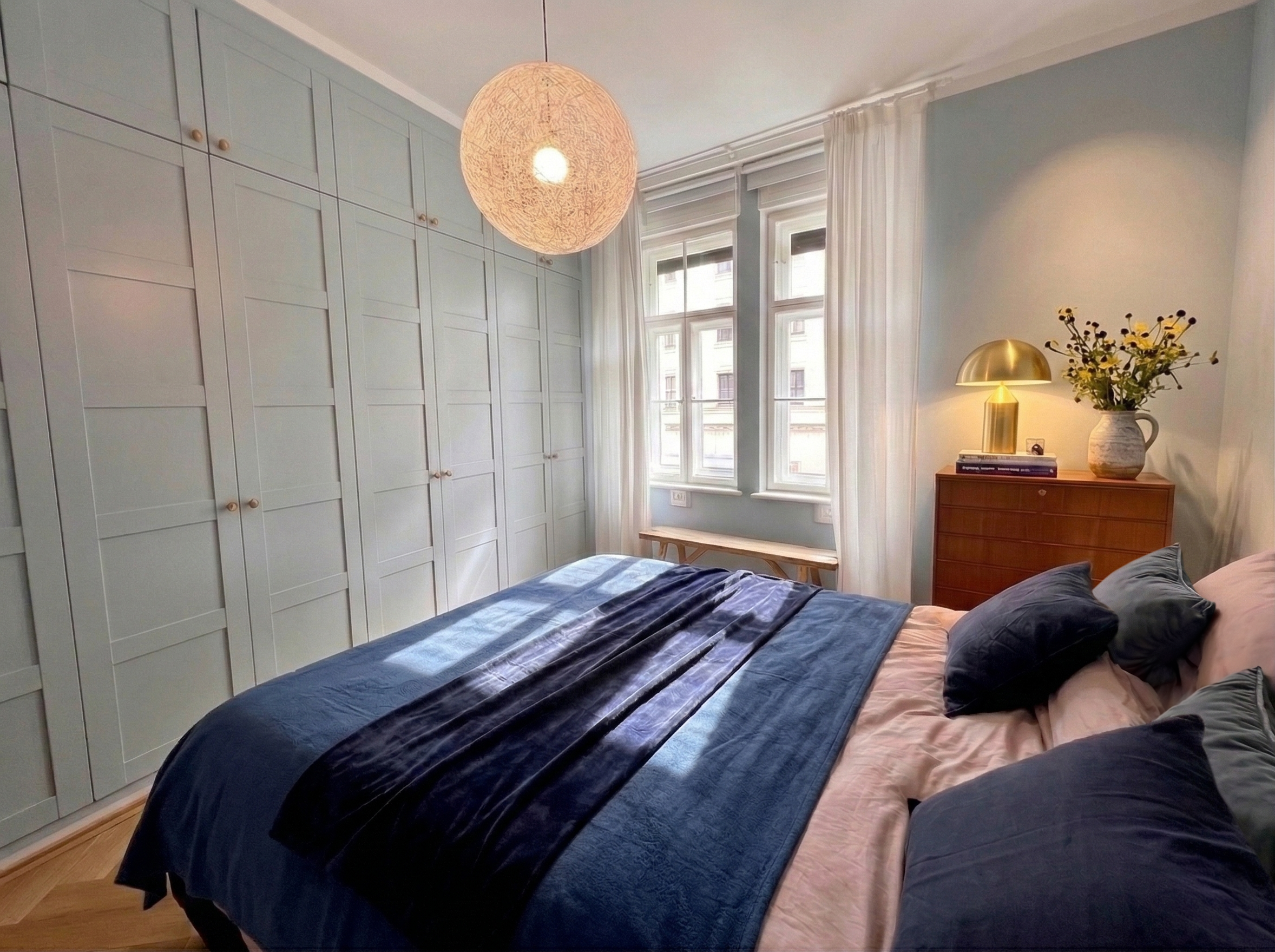 Farbkonzept im Schlafzimmer mit Farrow & Ball Parma Gray und dem Random Light von Moooi – kühles Blau trifft auf warme Textilien, Holz und weiches Licht.