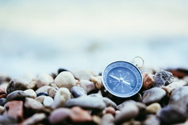 Compass laying on stones