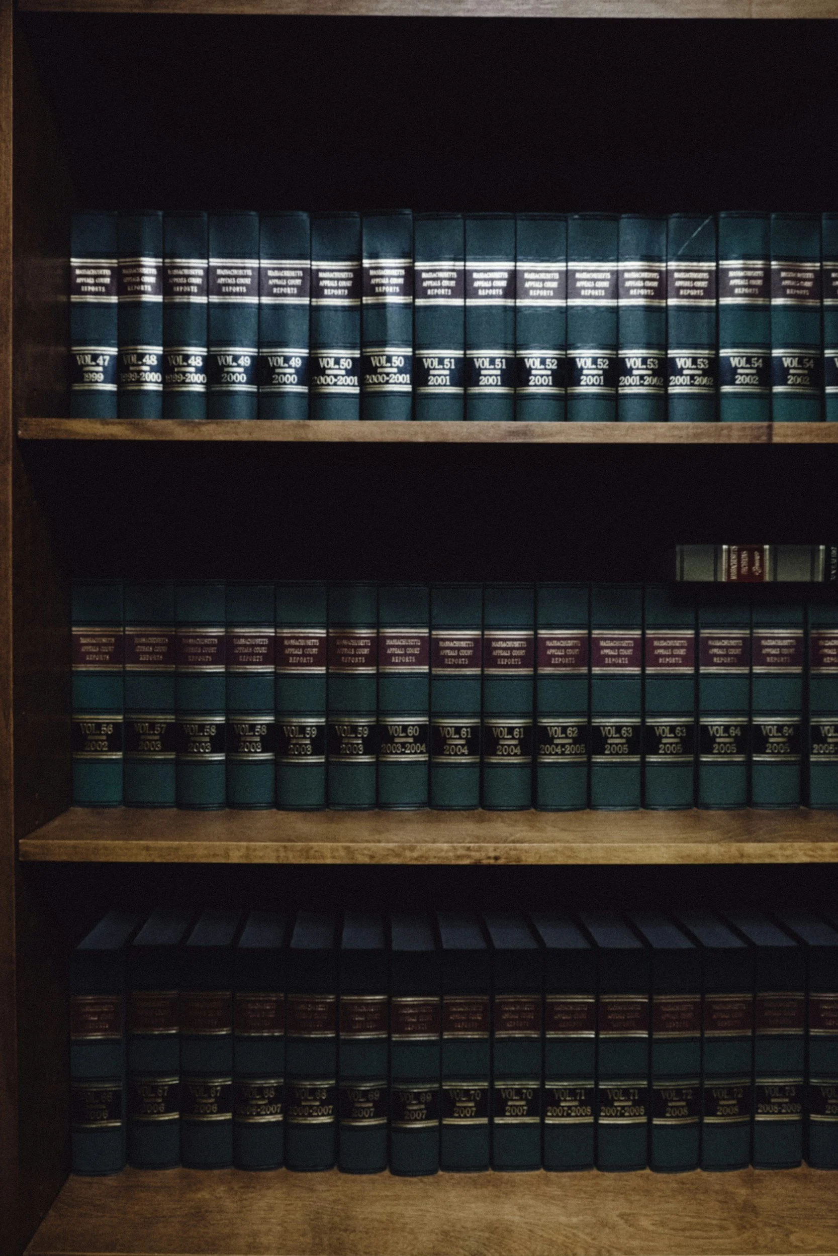 Bookshelf with law reports in three rows, labeled with volumes and years from 1999 to 2008.