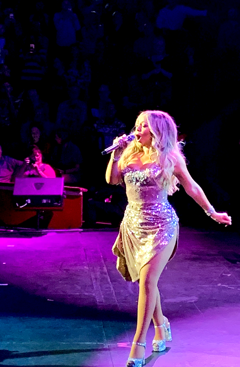 Mariah Carey in a glittery dress and high heels, performing at the Royal Albert Hall 2019.