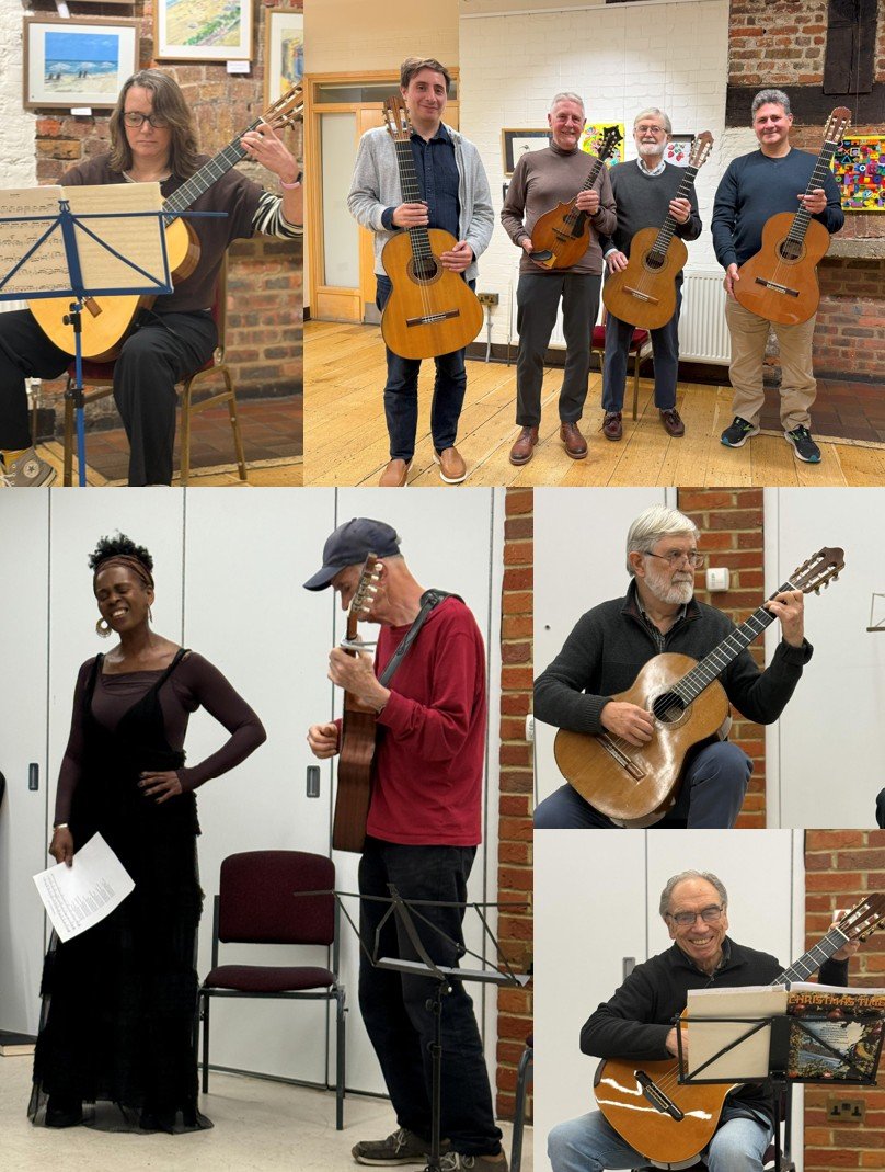 A group of musicians, some holding guitars, performing indoors. The setting has brick walls and framed pictures, likely an art gallery or cultural space.