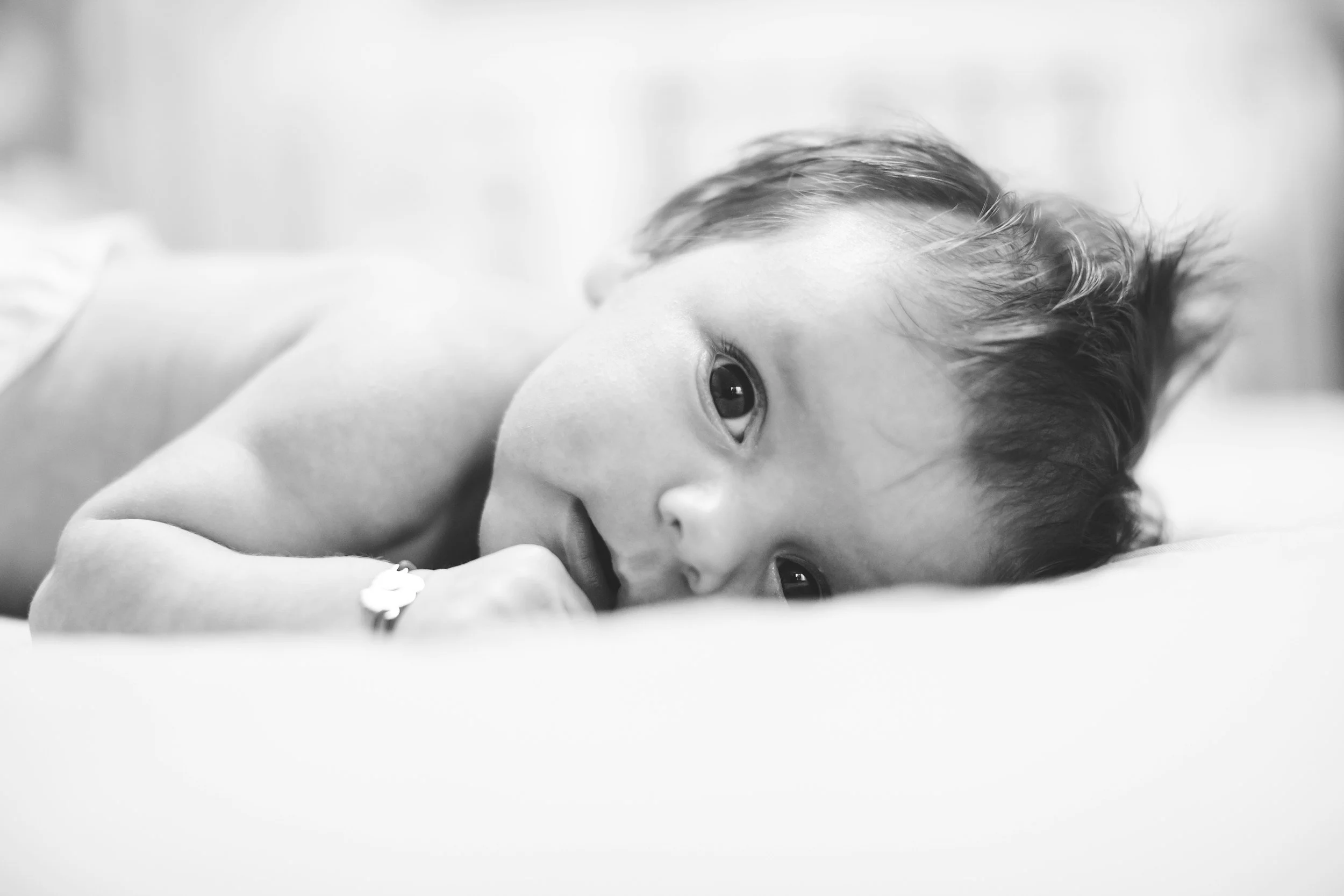 A baby doing tummy time on a blanket