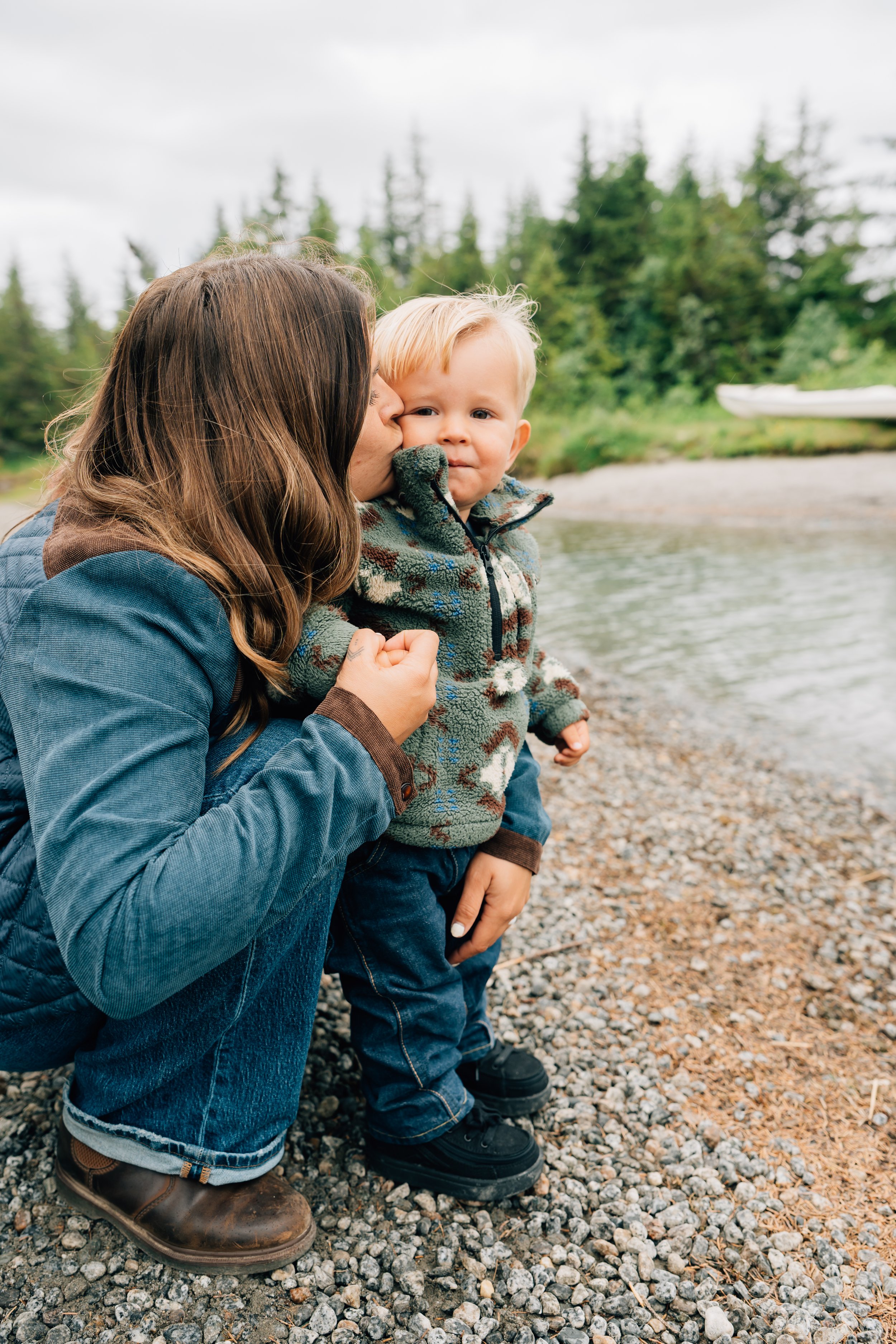 little boy skips rocks at mendenhall lake in juneau