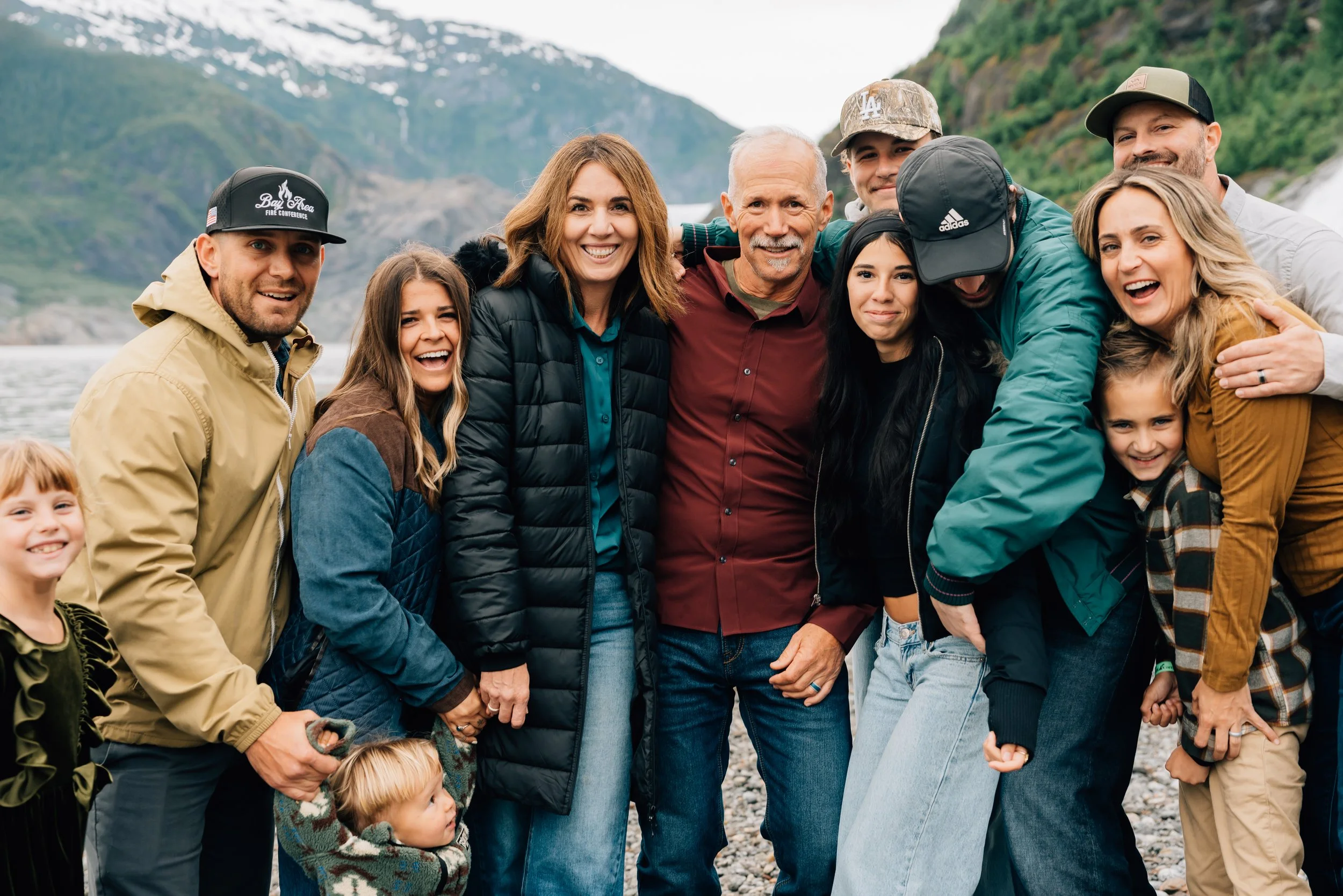 family gets their photo taken in front of Mendenhall Glacier Juneau Alaska