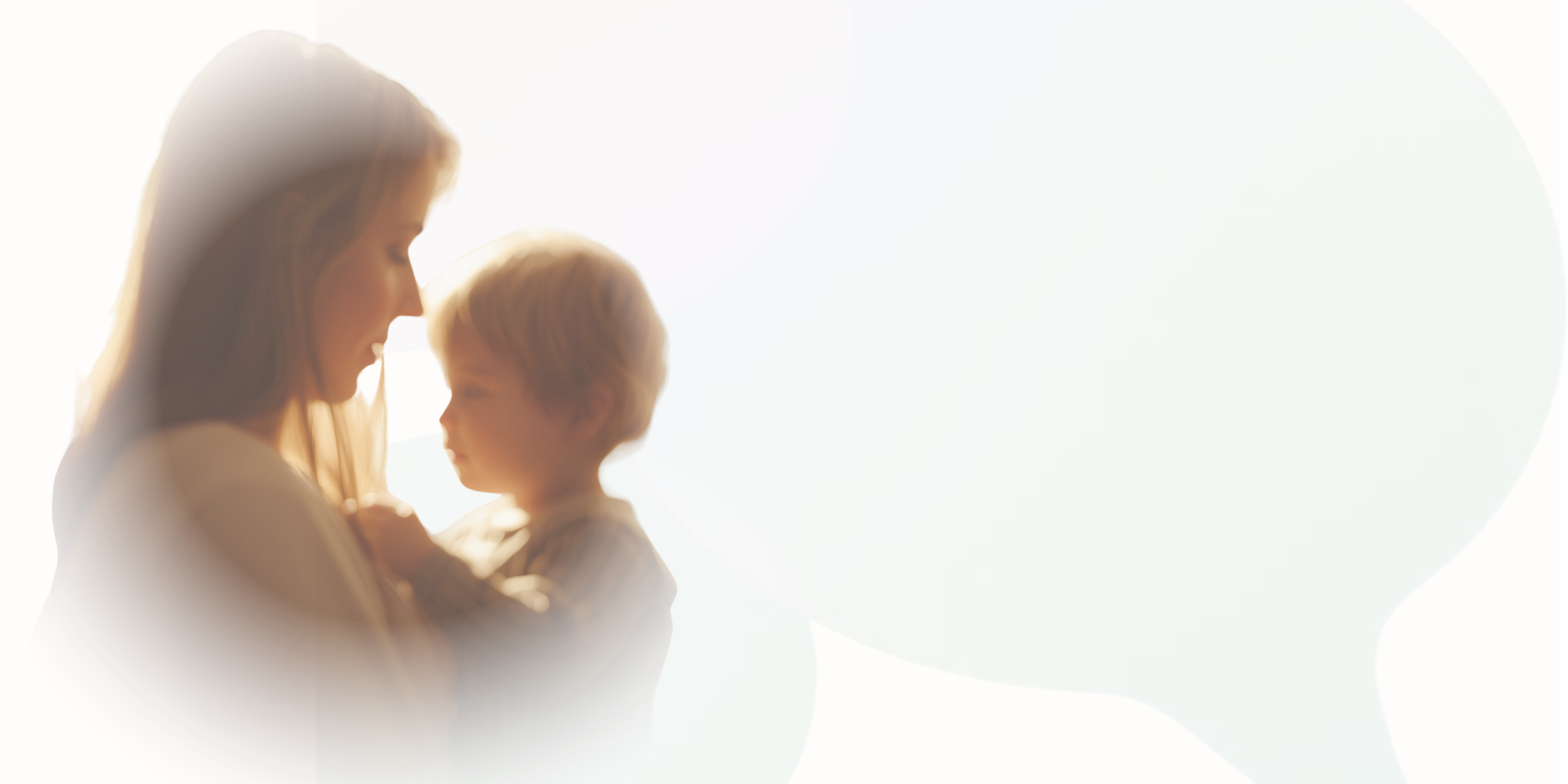 A blurred image of a woman and a child facing each other, with soft light illuminating their profiles.