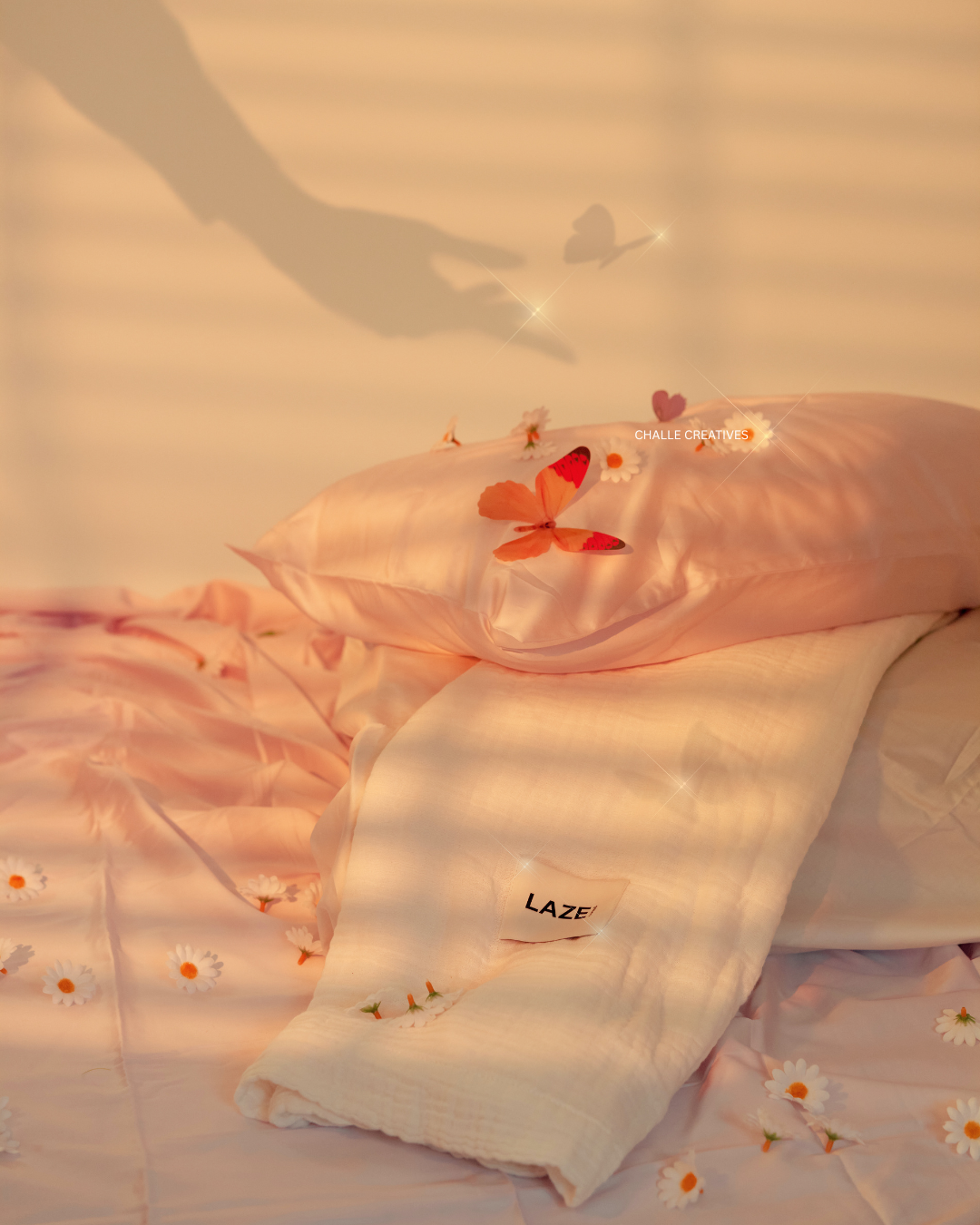 Soft pink and cream-colored bed with floral and butterfly decorations, including a pink butterfly on the blanket, daisies scattered around, and a shadow of a hand and butterfly on the wall.