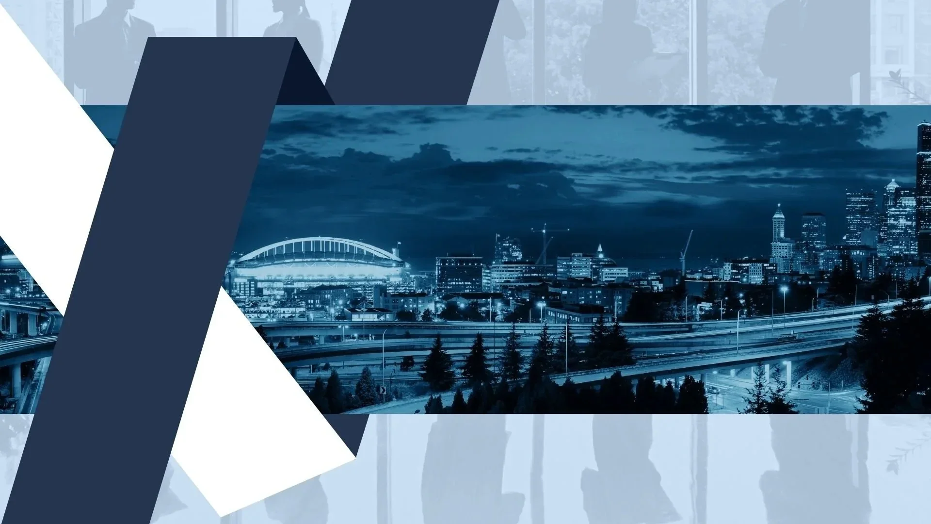 Nighttime cityscape with illuminated buildings, bridges, and highways in a modern urban area.