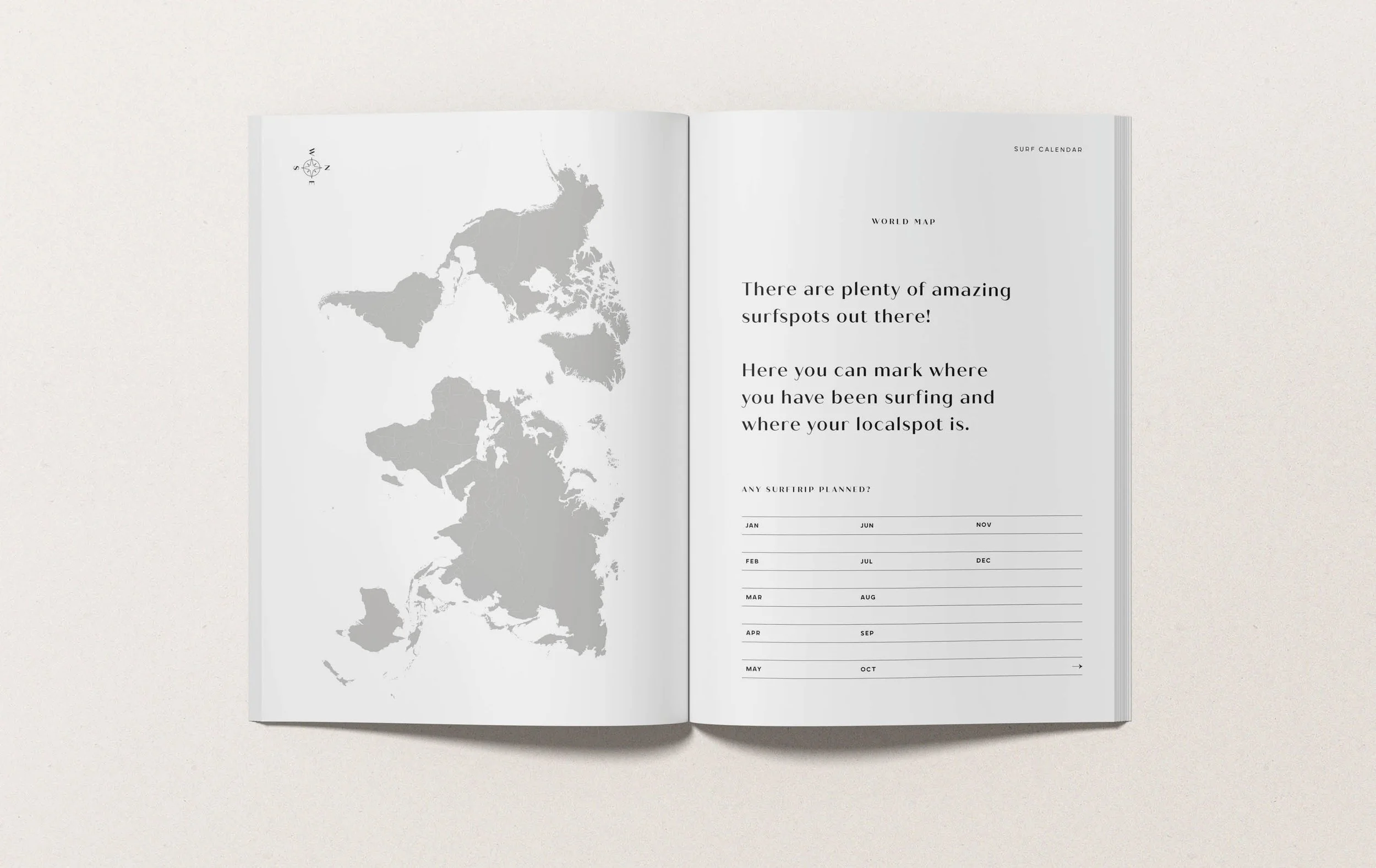 Open magazine or planner on a white surface, showing a map of the world on the left page and a surf calendar on the right page with months listed.