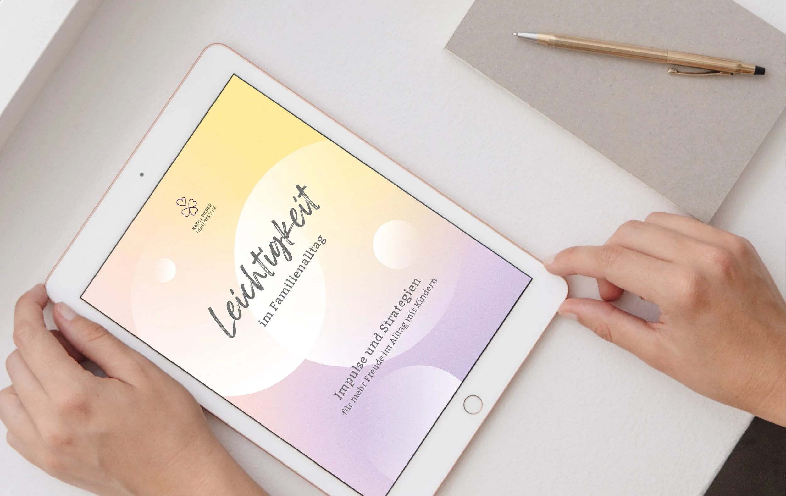 A person holding a white tablet displays a physical or digital book cover with pastel gradients and black text in German discussing happiness and strategy for children and families.