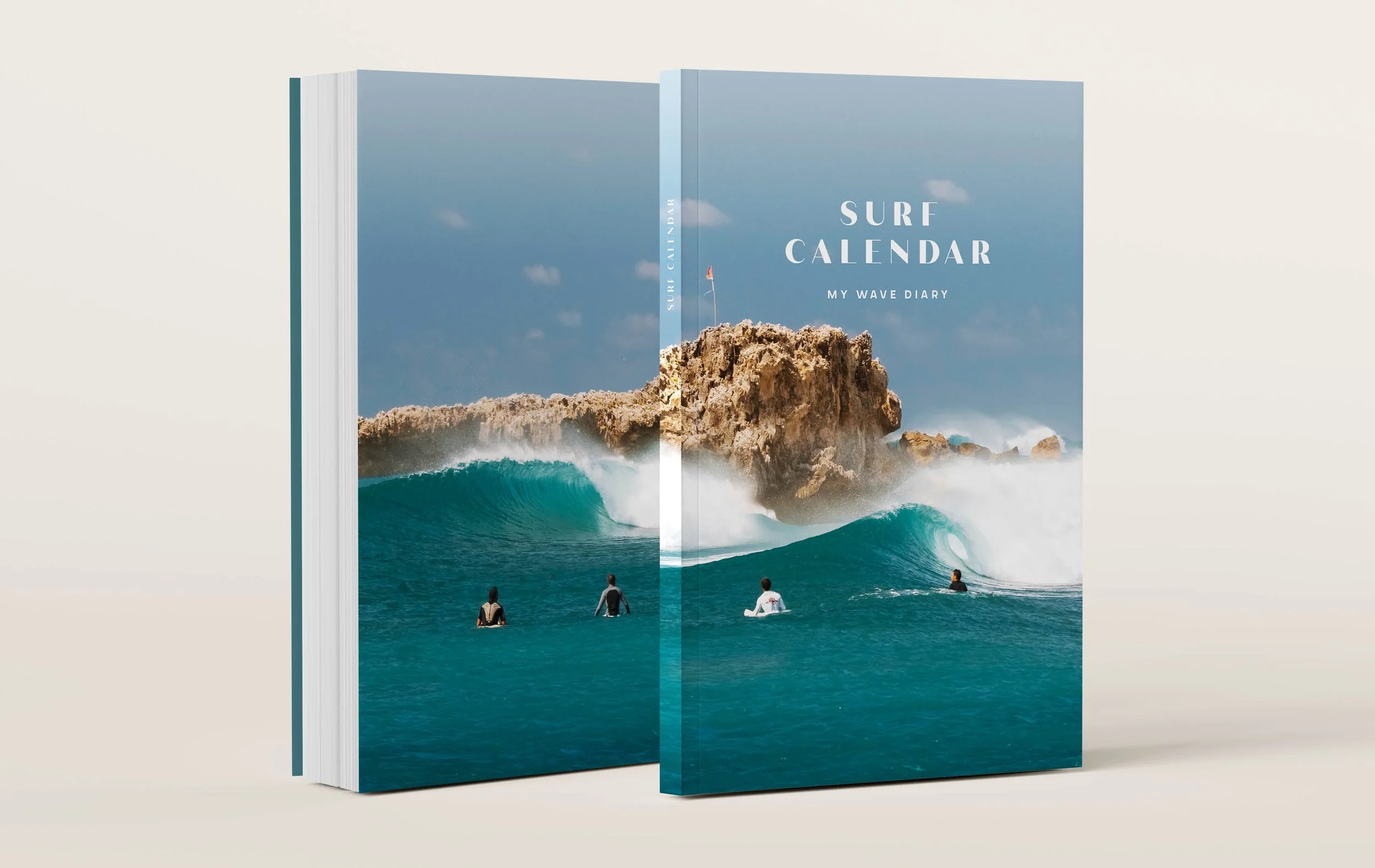 A surf calendar titled 'My Wave Diary' features an ocean scene with large waves crashing against rocks, a clear blue sky, and people in the water preparing to surf.
