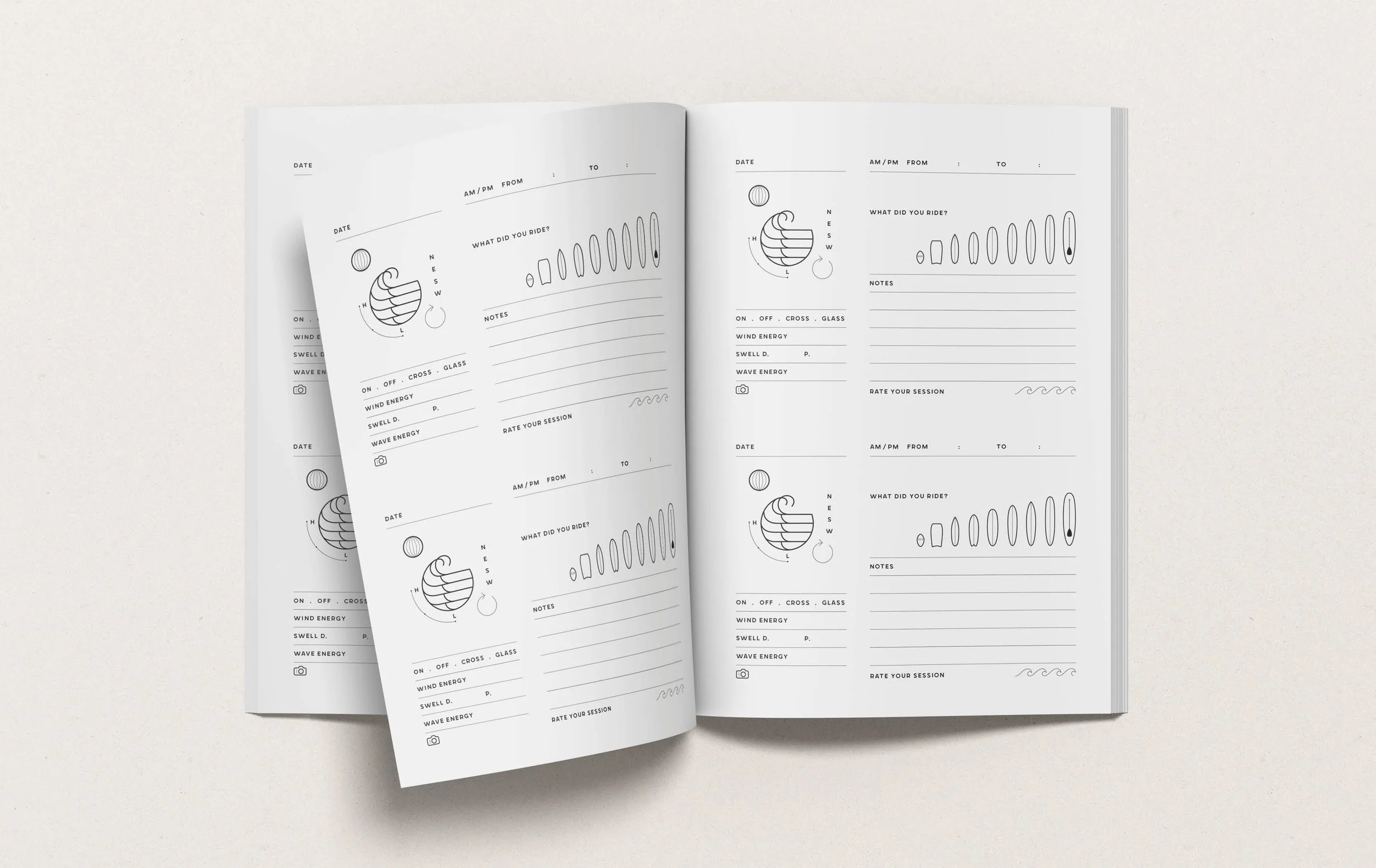 Open notebook with musical surfing session log pages on a white surface.