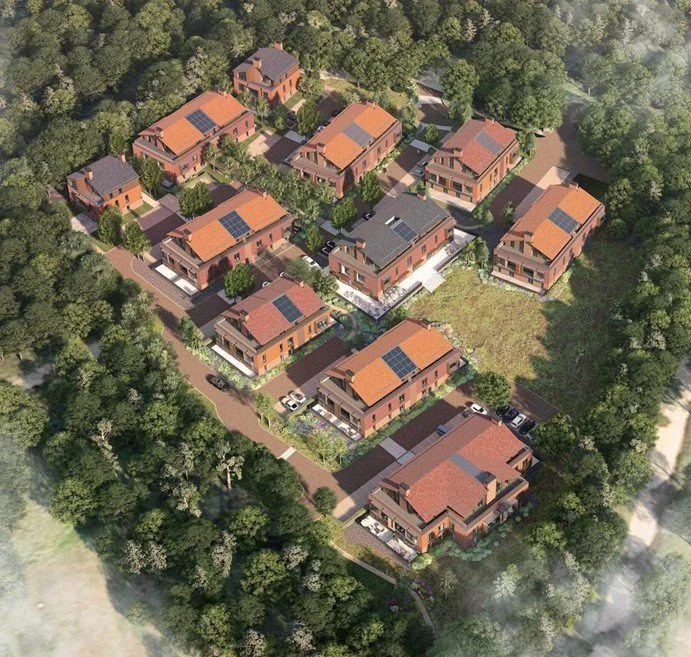 3D aerial architectural rendering of a proposed, unbuilt cointegrated retirement village scheme, showcasing multi-story red brick residential blocks with pitched clay-tile and grey roofs, integrated solar panels