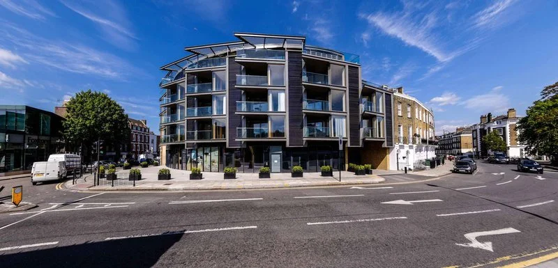 Modern multi-story apartment building on a city street.