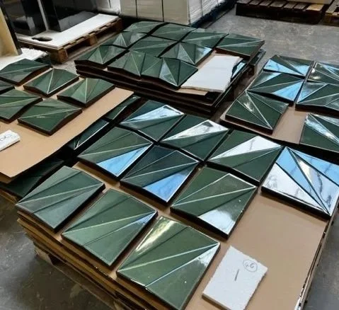 Multiple stacks of green, reflective, facette tiles in the material library.