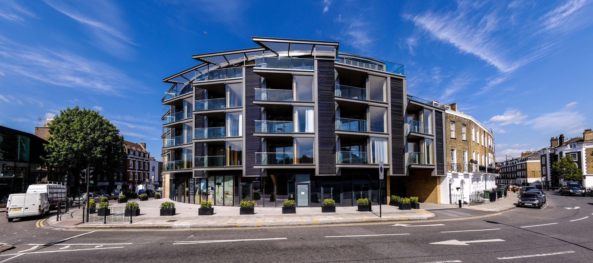 Mixed-used 5 storey apartment building in Camden, with a selection of sustainable features including 93m² of solar thermal panels on the facade.