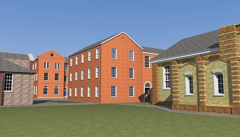 A row of brick buildings with multiple windows and an open grassy area in front, under a clear blue sky.