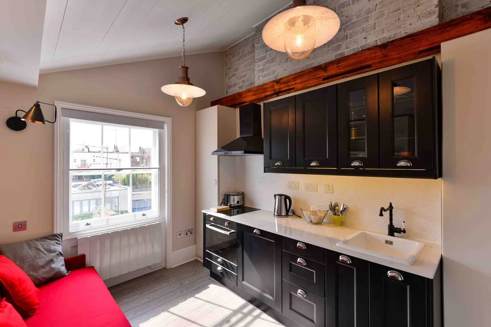 Interior photograph of a restored kitchen unit within a historic Listed building refurbished by Nick Baker Architects.