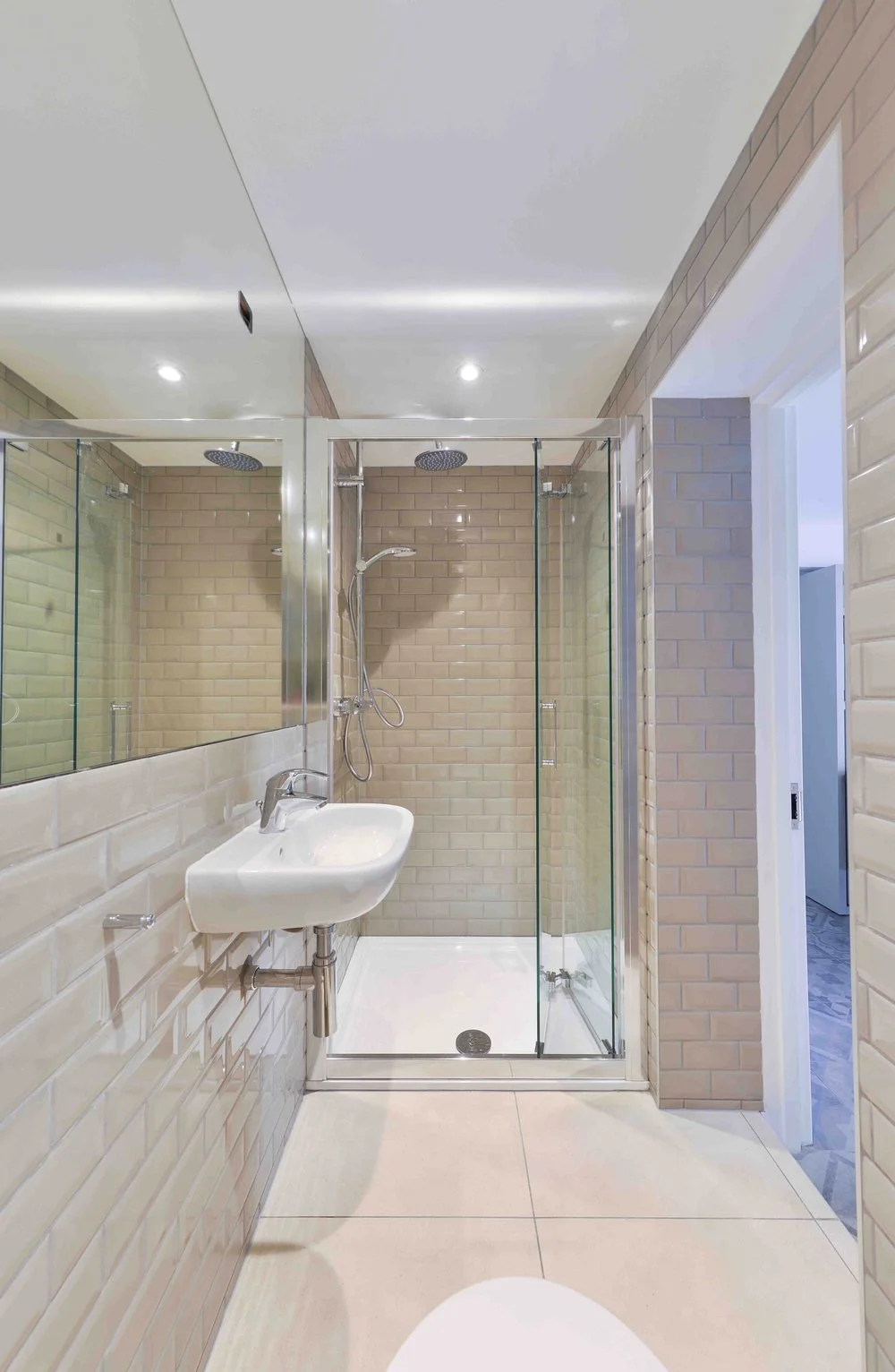 Interior photograph of a modern residential bathroom refurbishment by Nick Baker Architects, featuring a walk-in glass shower enclosure.
