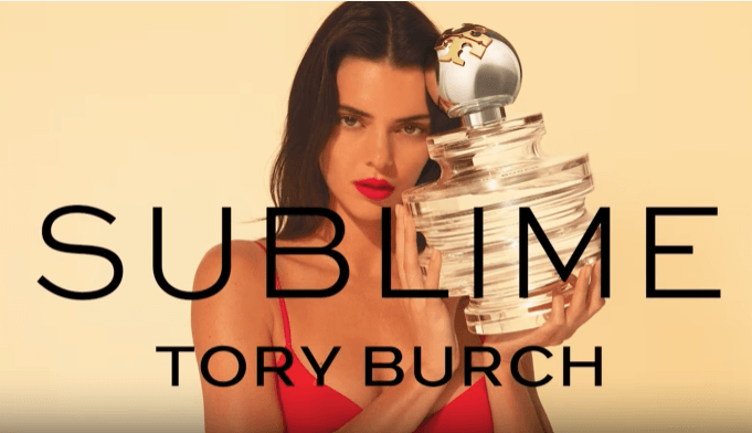Model holding Tory Burch Sublime  – elegant designer women’s fragrance.