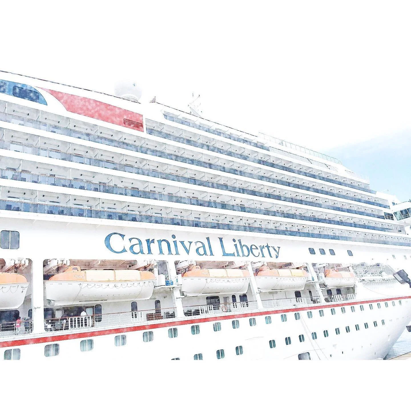 Side view of the Carnival Liberty cruise ship docked at port with multiple decks, lifeboats, and the ship's name visible.