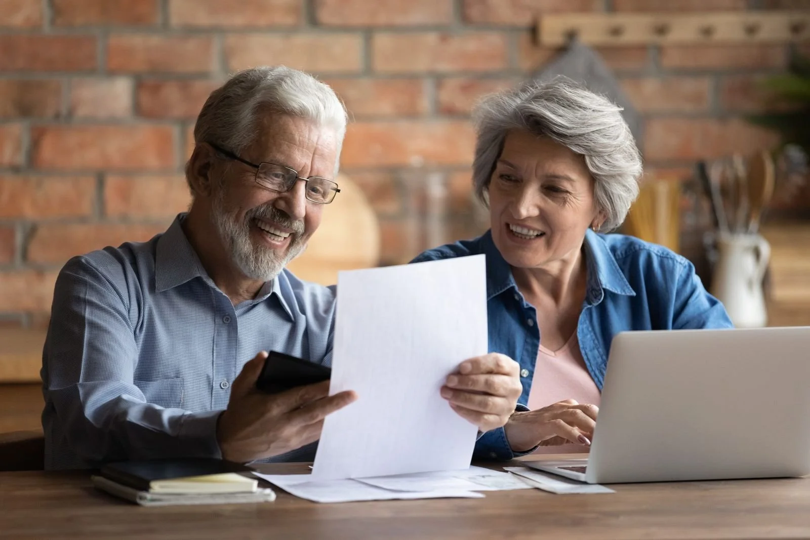 Older couple reviewing VA benefit paperwork together at home