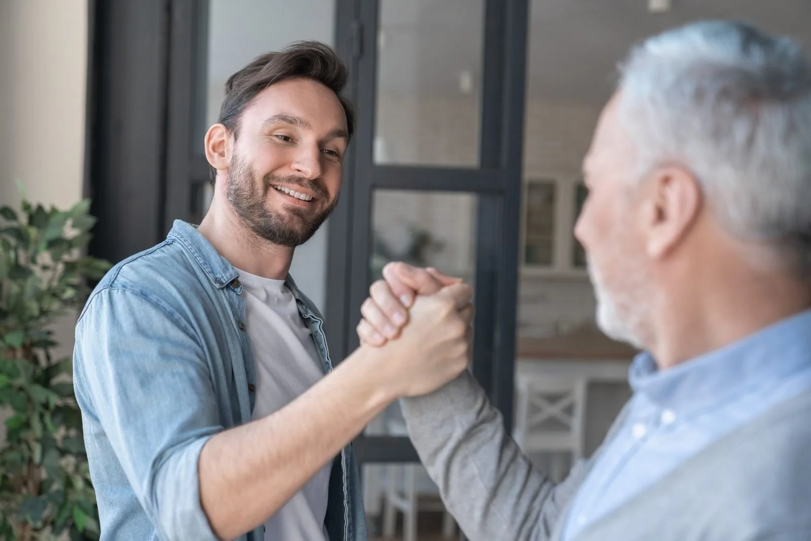 Advisor shaking hands with an older client