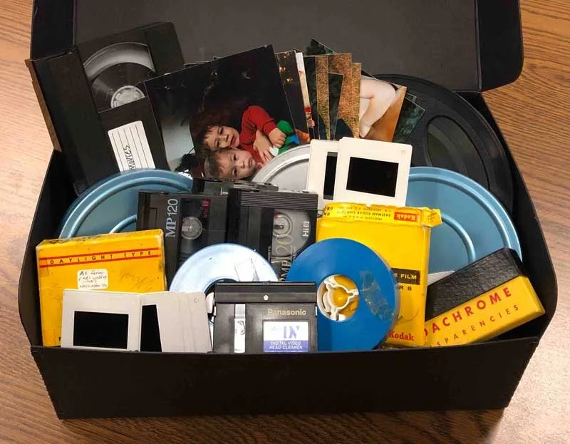 A box full of photos, slides, negatives, and movie tapes to digitize.