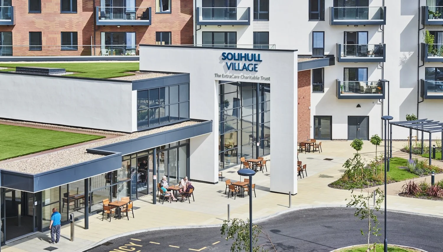 Modern senior living facility called SoulHill Village with outdoor seating and landscaped areas.