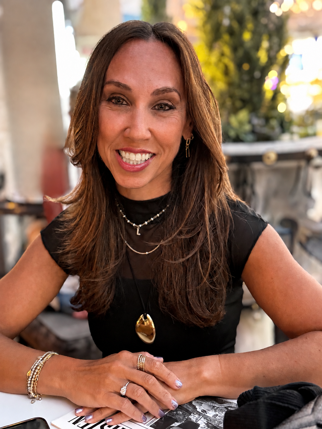 Lindsay Levine sitting at a table in the afternoon