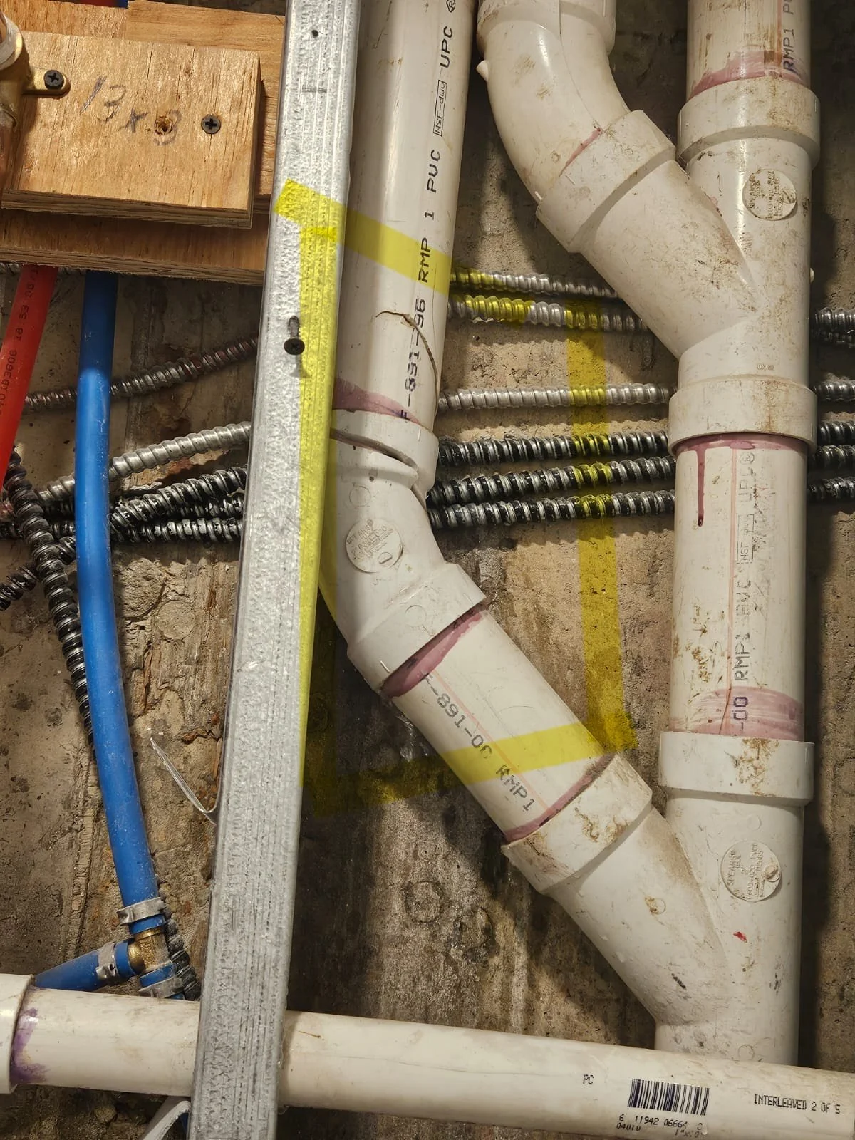 Water damage on Brooklyn apartment wall and floor from PVC pipe leak detected during NYC water leak inspection by New York Wall Repai