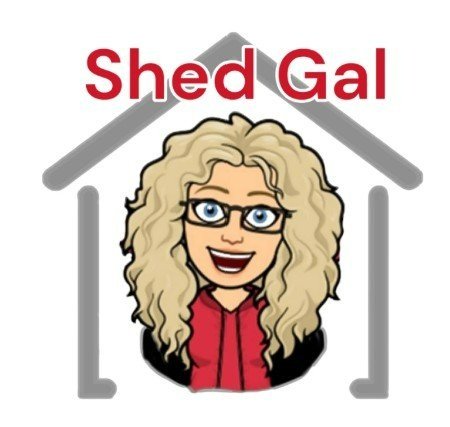 A cartoon woman with curly blonde hair, glasses, and a red shirt, smiling inside a house outline. The text above reads "Shed Gal" in red letters.