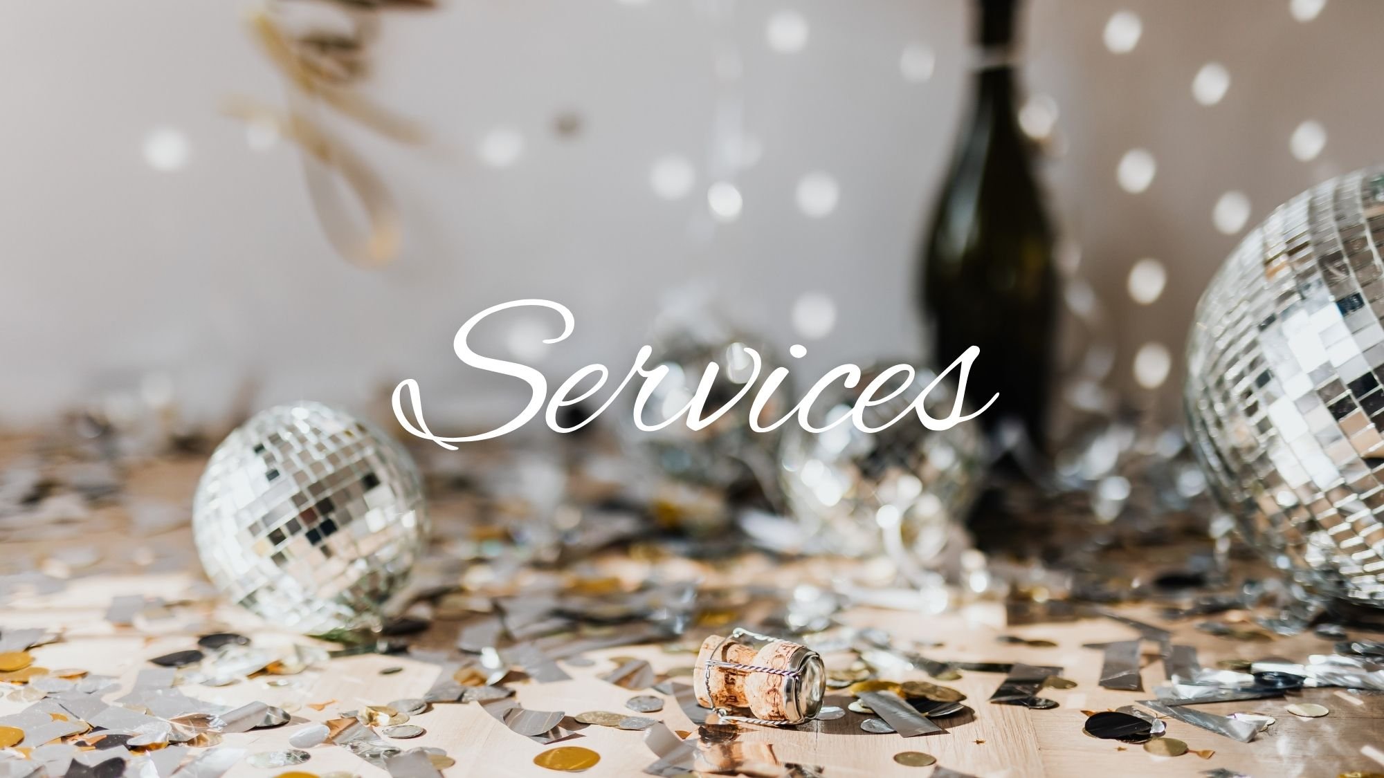 Decorative scene with disco balls, gold and silver confetti, and a champagne cork on a wooden surface, with the word 'Services' written in white cursive.