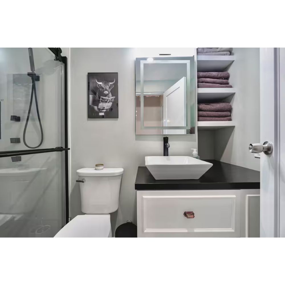 A modern bathroom with a shower, toilet, bathroom vanity with a vessel sink, mirror, and shelves with folded towels.